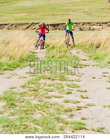 African Children Riding A Bike In Rural A Village