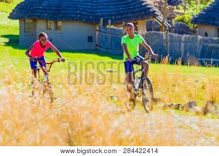African Children Riding A Bike In Rural A Village
