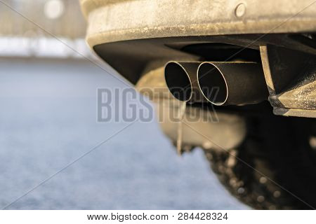 Close Up Exaust Pipe Of A Car Releasing Gas