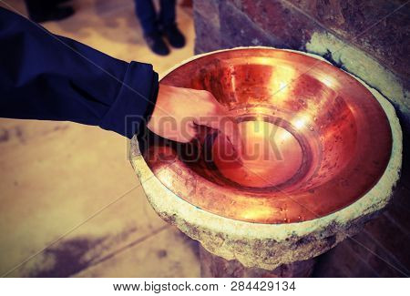 Hand Dip In The Blessed Stoup Water In Basilica And Vintage Old