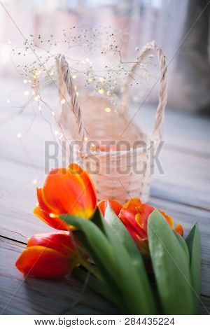 Tulips On A Wooden Background With Marshmallows In A Wooden Basket.
