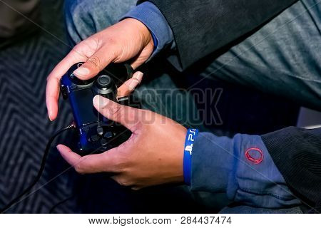 Play Station Ps4 Controller In A Gamers Hands