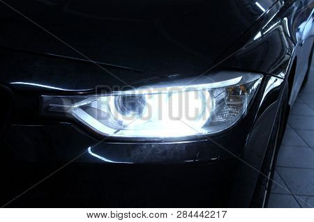 Macro View Of Headlight Detail Of Modern Automobile With Auto Projector Lens. Front View Of Vehicle 