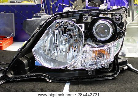 Macro View Of Repairing, Installation And Tuning Headlight Of Modern Automobile And Car Projector Le