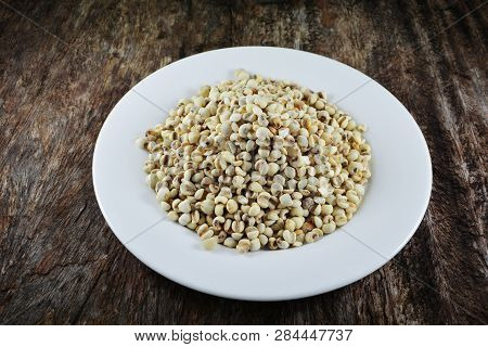 Job's Tears Coix Lachryma Jobi Grain Seeds On White Plate On Rustic Wood Background