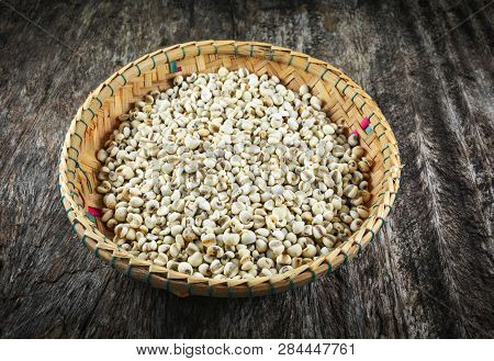 Job's Tears Coix Lachryma Jobi Grain Seeds On Bamboo Basket On Rustic Wood Background