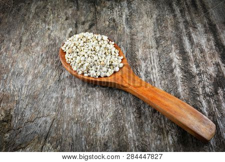 Job's Tears Coix Lachryma Jobi Grain Seeds On Wooden Spoon On Rustic Wood Background