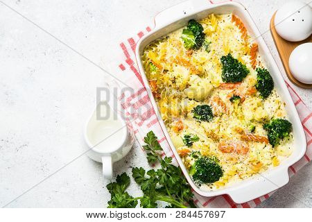Casserole From Pasta And Vegetables - Carrot, Broccoli And Cauliflower In Cream Sauce With Parmesan.