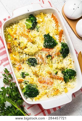 Casserole From Pasta And Vegetables - Carrot, Broccoli And Cauliflower In Cream Sauce With Parmesan.