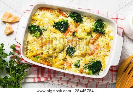 Casserole From Pasta And Vegetables - Carrot, Broccoli And Cauliflower In Cream Sauce With Parmesan.