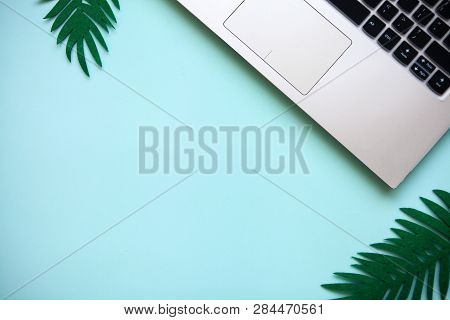 Workspace In A Blue Trendy Color Or Summer Design With A Concept To Start A Vacation. Laptop And Nex