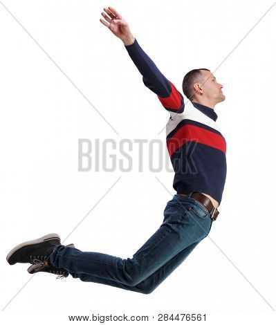 Side view of man in zero gravity or a fall. guy is flying, falling or floating in the air.  Isolated over white background. The guy in the jacket hovered in the jump, arms outstretched to the sides.