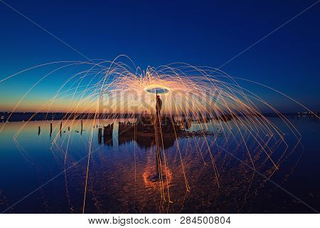 Amazing Fireshow Performance In The Night Blue Sky With Reflections In The Sea Water