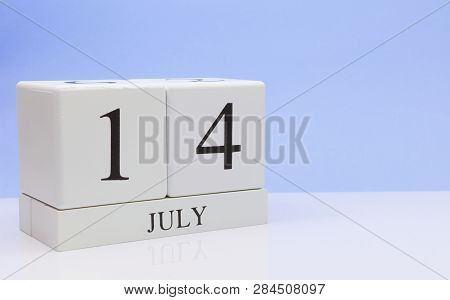 July 14st. Day 14 Of Month, Daily Calendar On White Table With Reflection, With Light Blue Backgroun