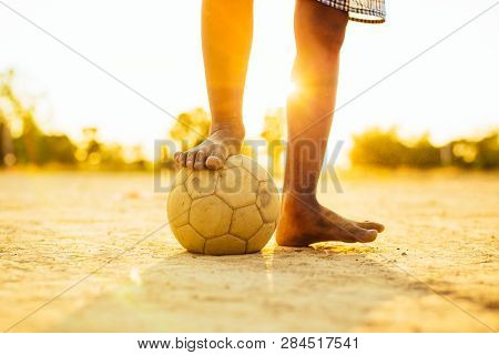 Kids Are Playing Soccer Football For Exercise In The Community Rural Area.