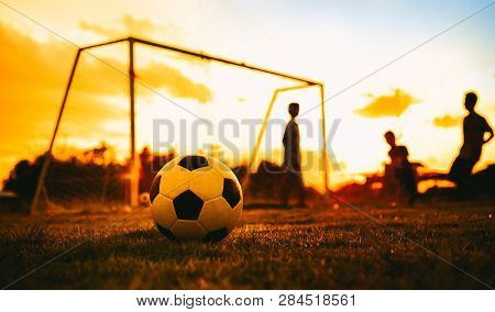 Silhouette Action Sport Outdoors Of A Group Of Kids Having Fun Playing Soccer Football For Exercise 