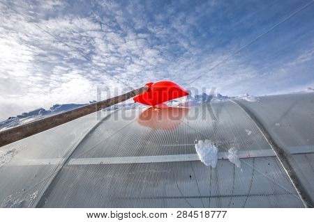 Snow Removal From Polycarbonate Greenhouse In Winter. Berdsk, Novosibirsk Region, Western Siberia, R
