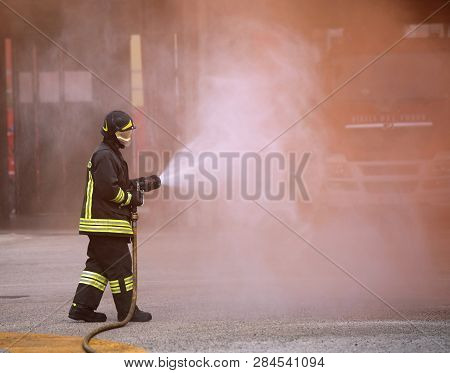 Italia, It, Italy - May 10, 2018: Firefighter Uses The Hydrant With Foam During A Practice Fire Dril