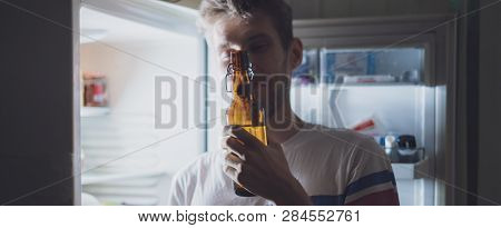 Man Drink Bear From Refridgerator At Night Time