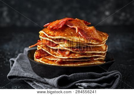 Pancakes With Crispy Bacon And Maple Syrup In Cast Iron Skillet, Frying Pan. Morning Breakfast