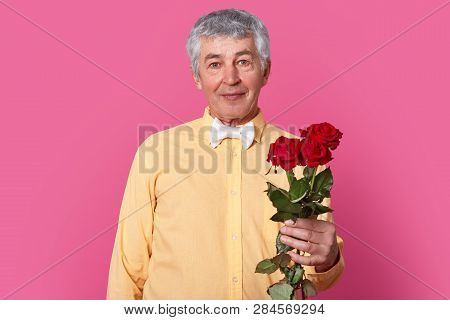 Elegant Romantic Mature Gentleman In Formal Shirt With Bowtie Holds Red Roses, Ready For Date Or Bir