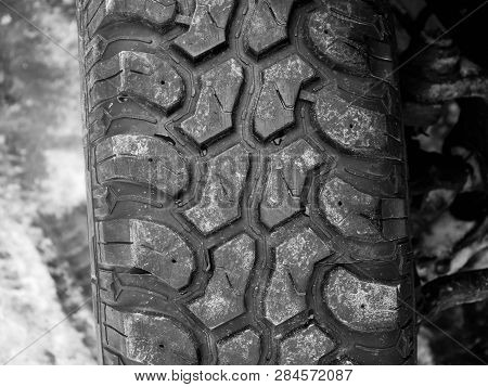 Terrain Tyre Close Up Shot On Offroad Vehicle At Roadside.
