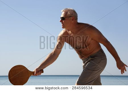 Portrait Of A Man Playing Beach Tennis