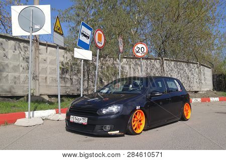 Moscow. Autumn 2018. Black Volkswagen Golf Mk 6 Tuned By Air Suspension.  Low Car With Wide Orange W