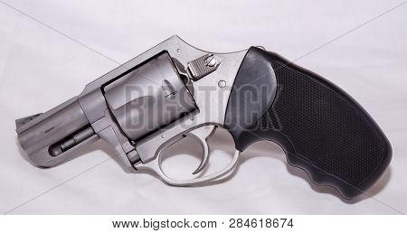 A Stainless 357 Magnum Revolver Shown On A White Background
