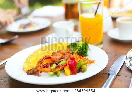 Omelet With Pepper, Cucumber, Bakon And Salad On The Table Outdoors