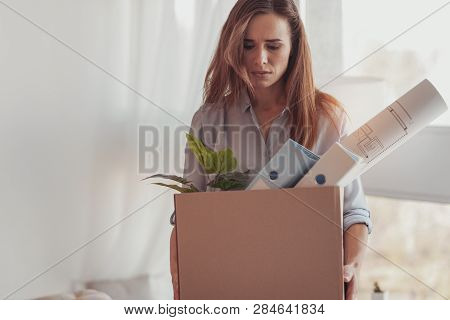 Sad Downhearted Woman Holding A Box With Her Office Stuff