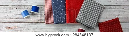 Etsy Big Banner. Top View To Some Blue And Red Pachwork Fabrics And Threads Placed On Light Grey Woo