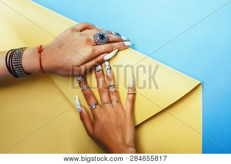 Woman Hands Holding Colorful Paper Copyspace Wearing A Lot Of Jewelry And Long Nails