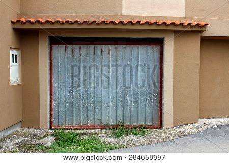 Grey Metal Garage Doors Waiting For Fresh Paint Mounted On Newly Constructed Garage Wall With New Fa