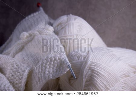 The Process Of Hand Knitting White Wool Scarf. Knitted Clothes For Women. Handmade Threads Concept. 