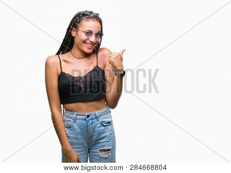 Young braided hair african american with birth mark wearing sunglasses over isolated background doing happy thumbs up gesture with hand. Approving expression looking at the camera