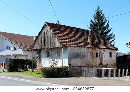 Small Dilapidated Family House Made Of Wood And Concrete Abandoned By Owners With Cracked Facade And