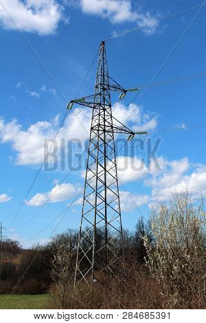 Tall Metal Electrical Power Line Utility Pole Made Of Strong Metal Pipes With Multiple Electrical Wi