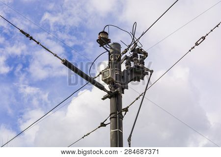 Small Transformer On The Electric Pole. City, Mains Electricity. High Voltage Line