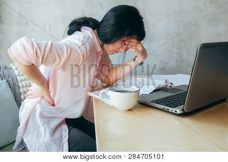 Tired Upset Young Businesswoman Suffering From Strong Chronic Backache Or Osteochondrosis At Work, S