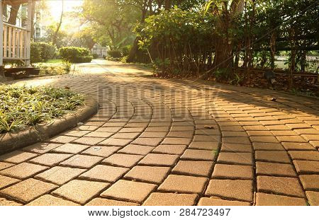 Garden Curving Stone Block Pathway In The Gentle Sunlight