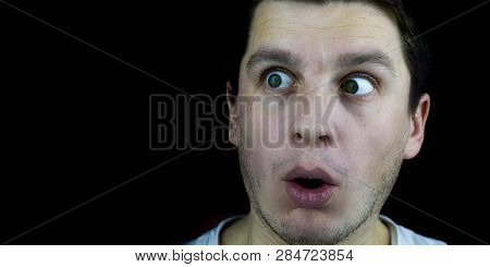 Surprised By Surprise, An Unshaven Man On A Black Background With Large White Eyes And Dark Hair. Th