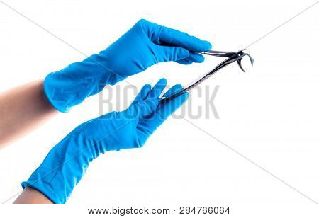 Hands in blue gloves holding dental flatterns isolated on white background