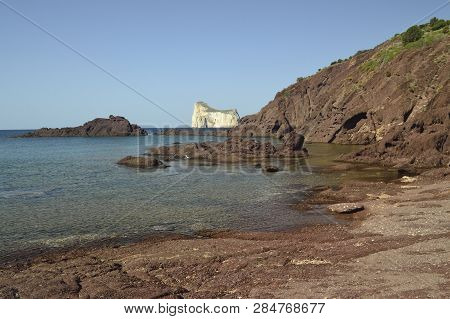 The Beach Of Porto Corallo, In Background The Pan Di Zucchero