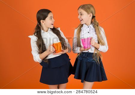 Tea Break. Girls Kids School Uniform Orange Background. Schoolgirl Hold Mug. School Lunch. Having Br