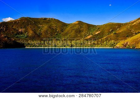 Secluded, Coconut Tree Filled Beach Off Naviti Island With A Warm Late Afternoon Sunkissed Glow And 