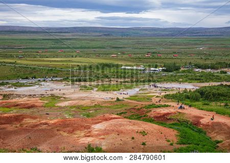 Tourists at Haukadalur geothermal valley waiting for the Great Geysir or Strokkur geysir to erupt. Geysir is one of the most popular tourist destinations on Golden Circle Tourist Route in Iceland