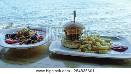 Seafood Spaghetti With Beef Hamburger For Lunch At Seaside Restaurant.