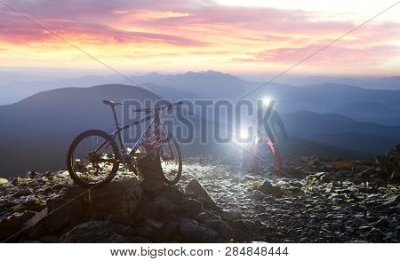 Placers With Rocks On The Steep Carpathian Slope In The Morning At Sunrise, A Lone Rider Racer Climb