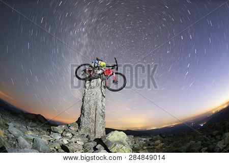 Bike On A Stone Pillar Tops At Night